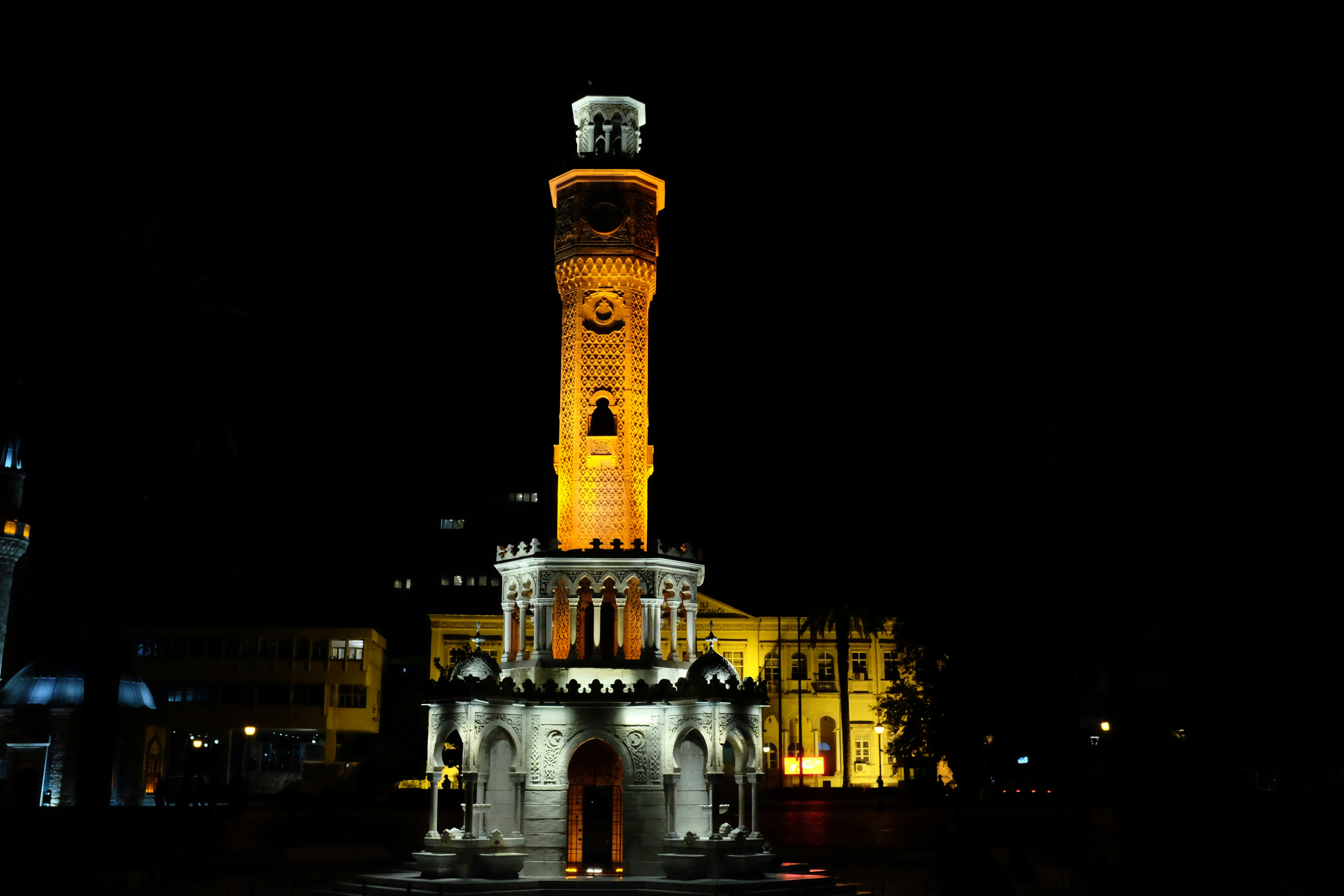 a tall clock tower lit up at night