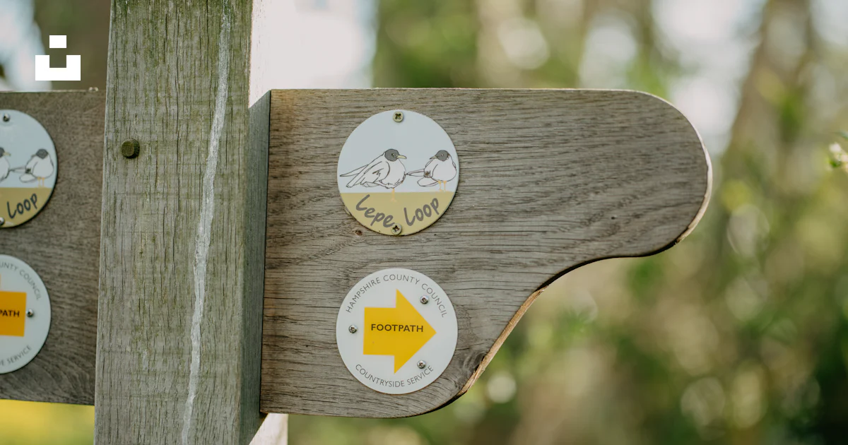 A close up of a wooden sign with stickers on it photo – Free Signpost ...
