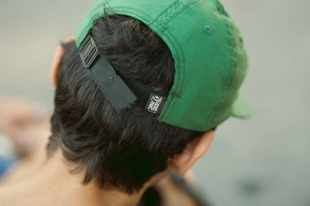 a man with a green hat on top of his head