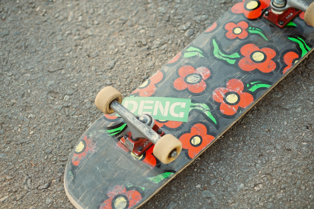 a skateboard with flowers painted on it sitting on the ground