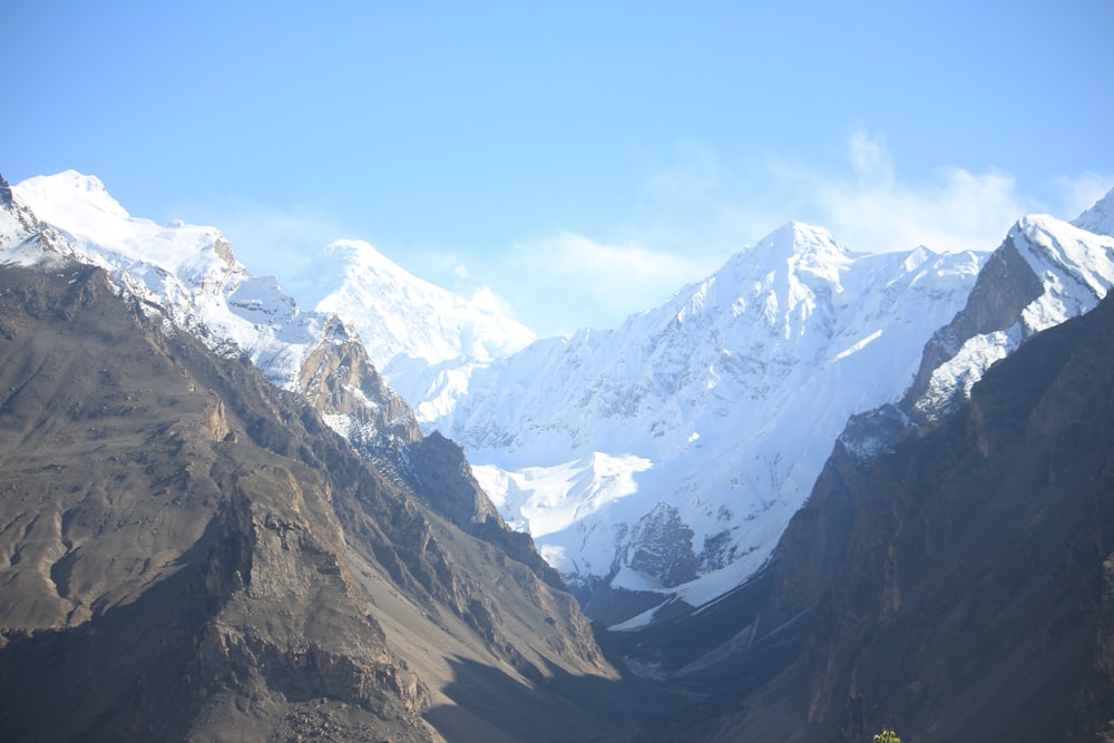 a mountain range with snow covered mountains in the background