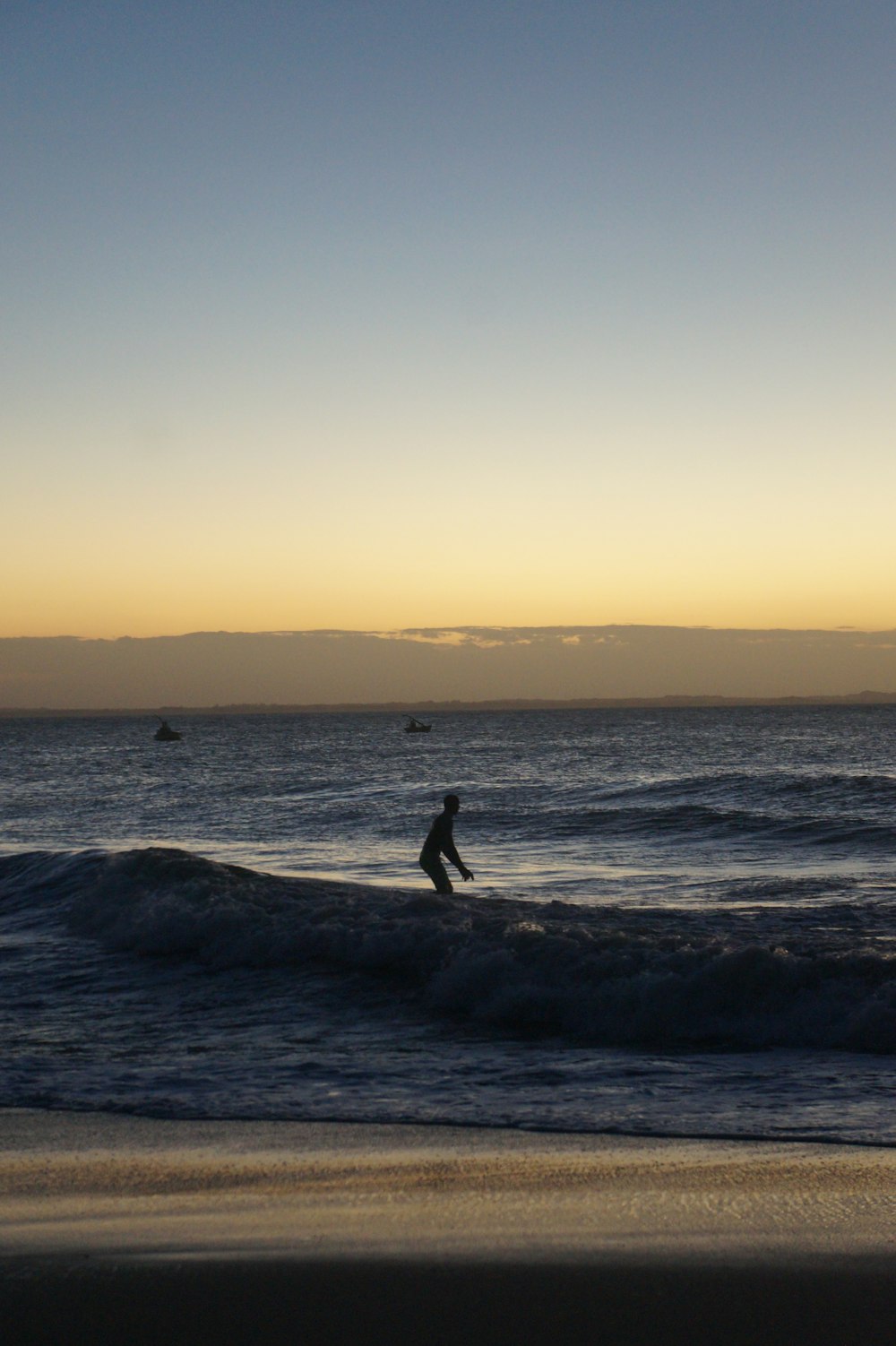 a man riding a wave on top of a surfboard