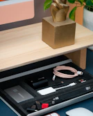 Assortment of promotional keychains and USB drives spread on a modern office desk.