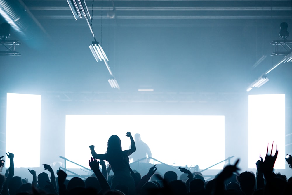 a group of people standing in front of a stage