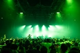 a crowd of people standing on top of a stage