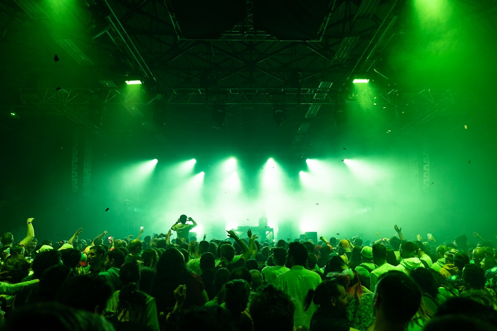 a crowd of people standing on top of a stage