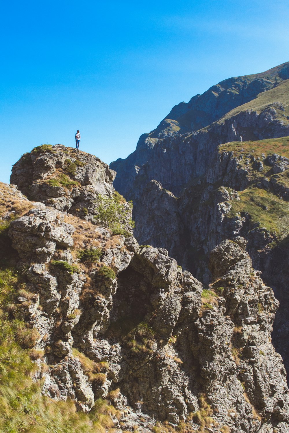 a person standing on top of a rocky mountain