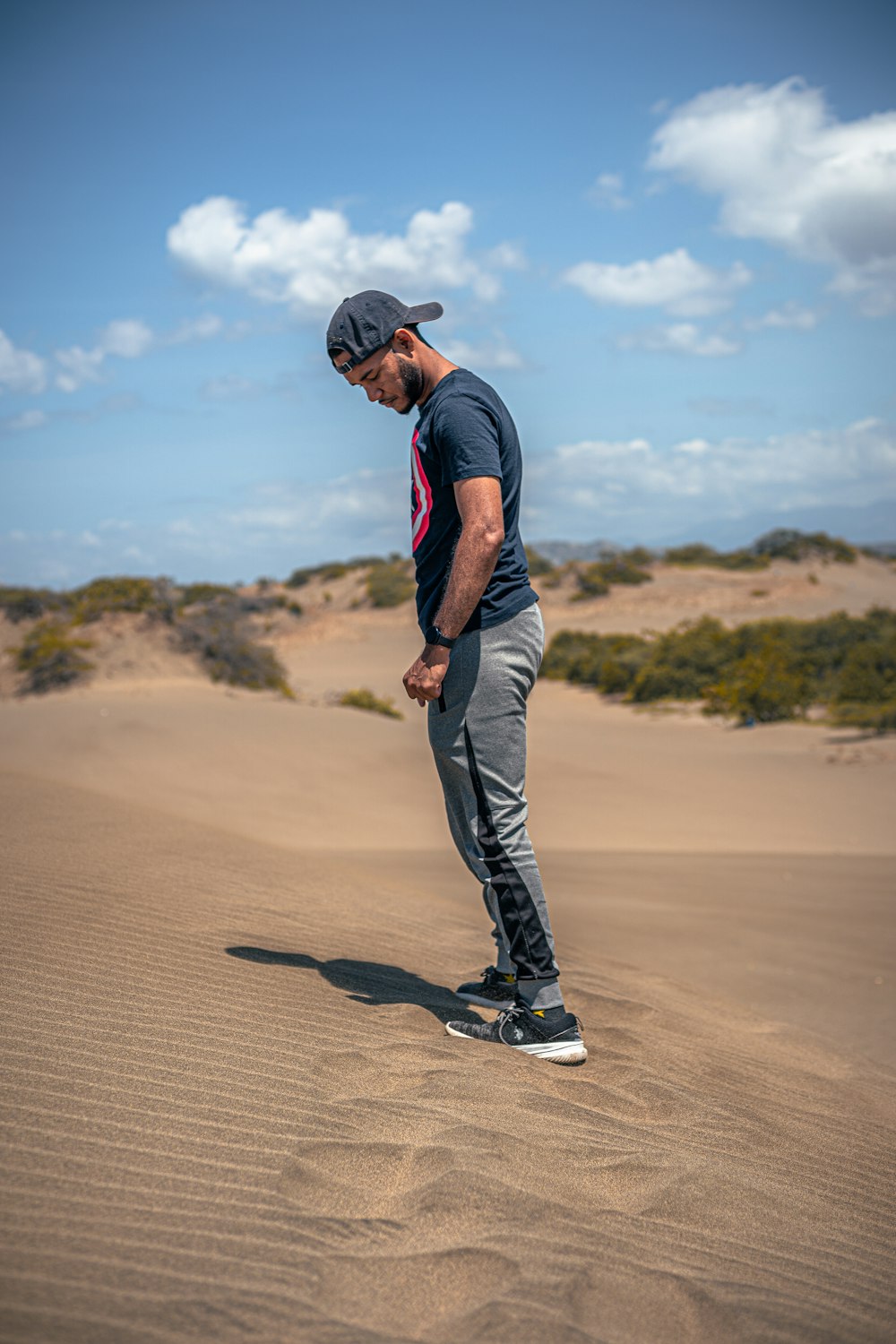 a man riding a skateboard on top of a sandy beach