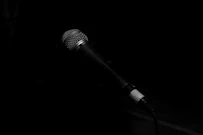 A sleek microphone on a stage ready for a corporate event host