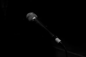 A sleek microphone setup glowing softly against a dark background, perfect for streaming.
