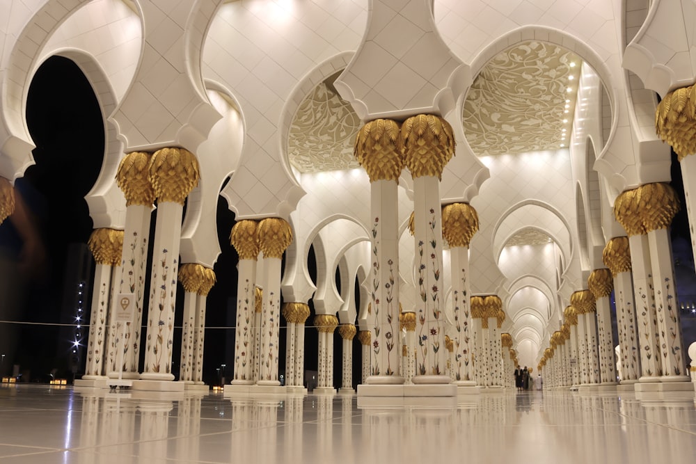 the interior of a building with columns and arches