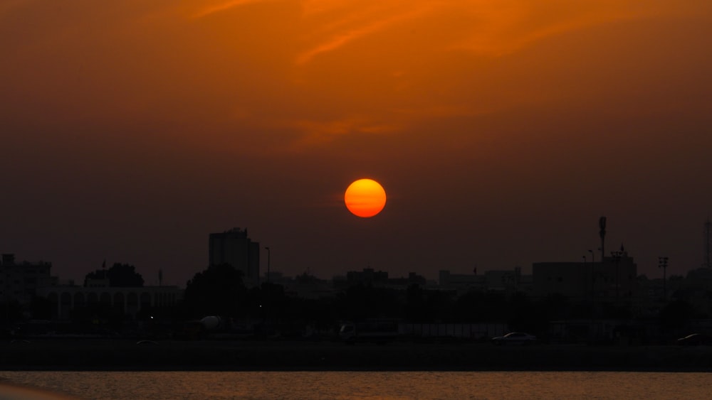 the sun is setting over the city skyline