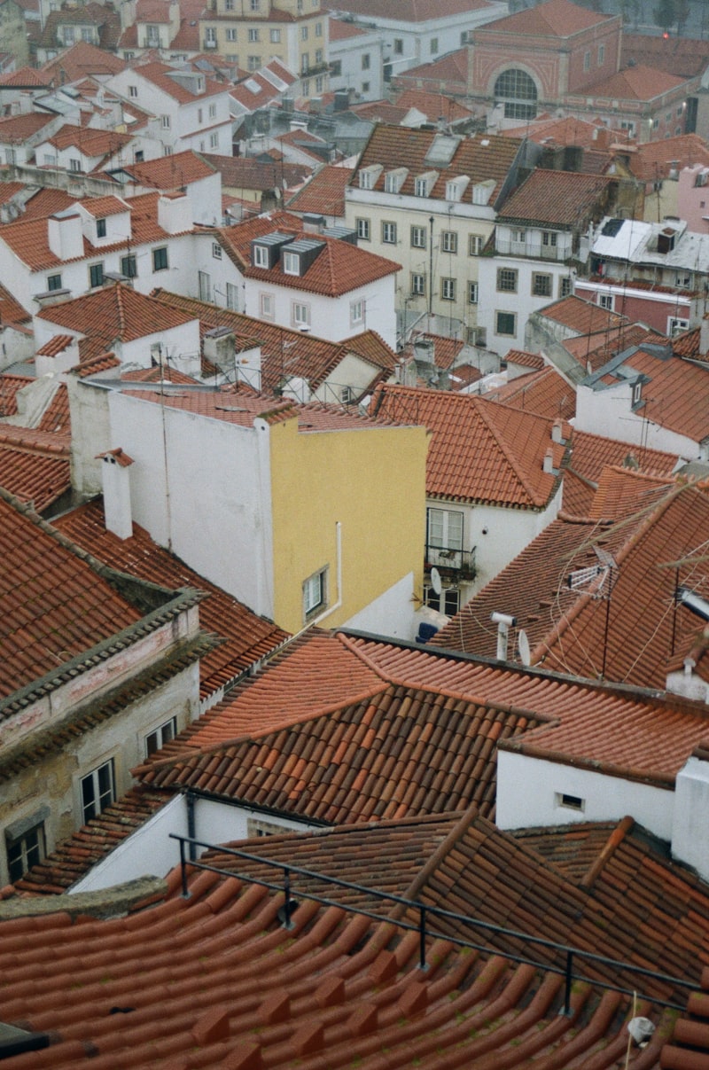 Panoramic view over Lisbon's terracotta rooftops towards the Tagus River