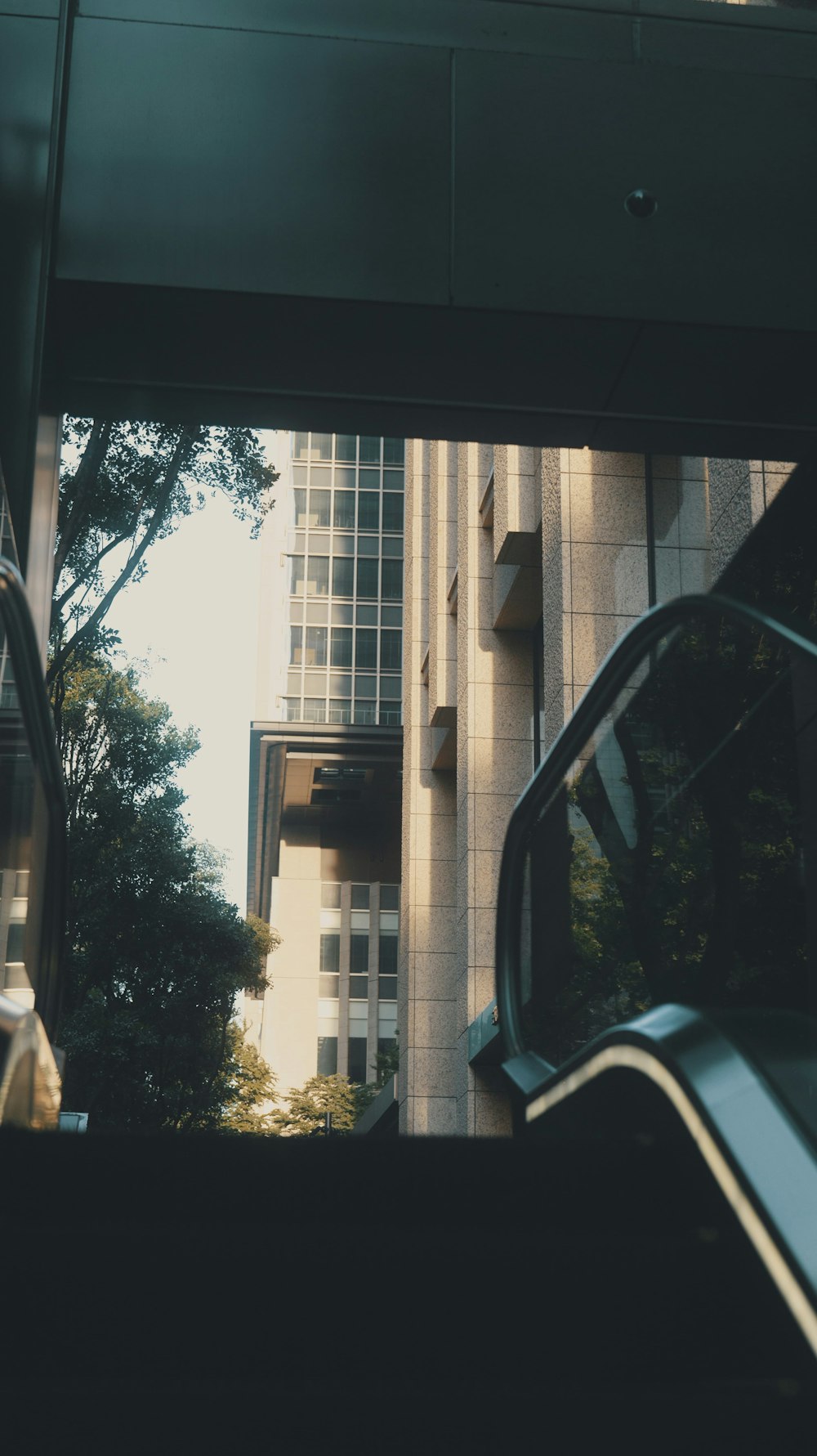 a view of a building from inside a bus