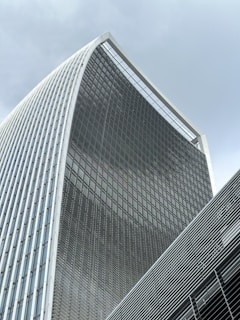 A sleek, modern office building with glass façades reflecting the sky, symbolizing imarat's innovative real estate vision.