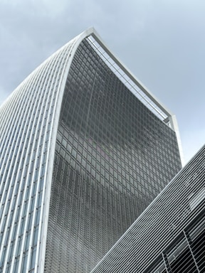 A sleek, modern office building with glass façades reflecting the sky, symbolizing imarat's innovative real estate vision.