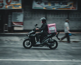 a man riding a motorcycle down a street
