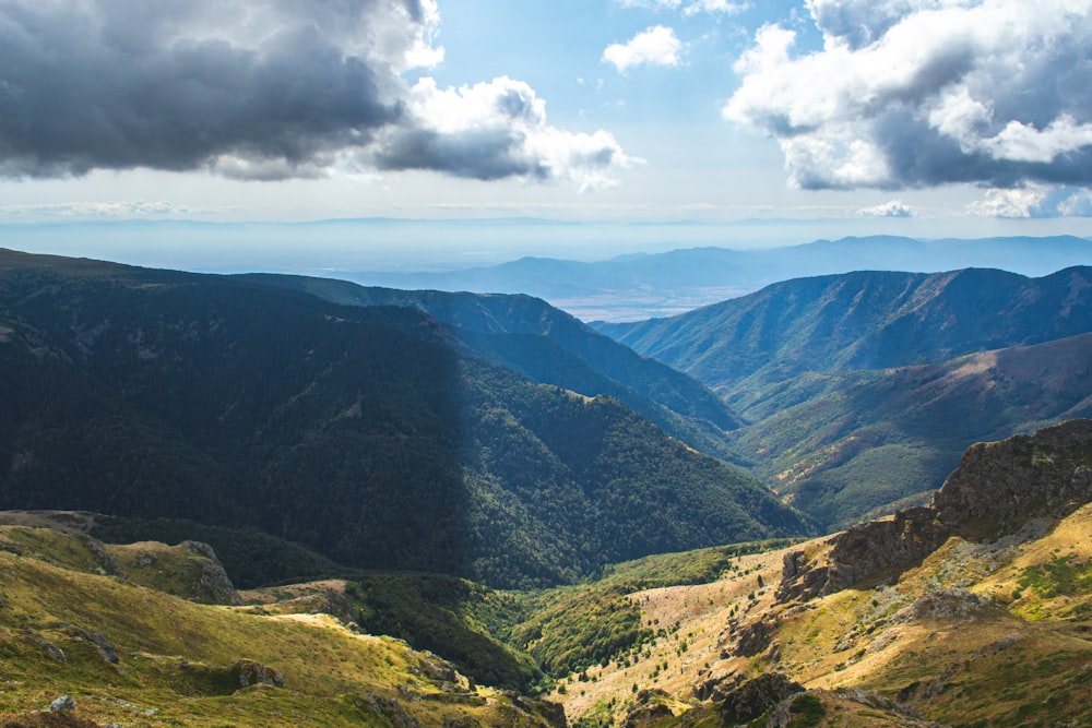 a view of a valley with mountains in the background