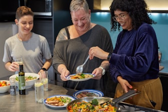 a group of people preparing food in a kitchen