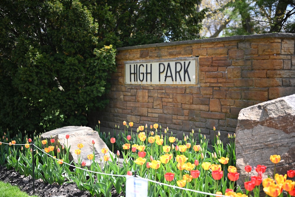 a sign that reads high park in front of some flowers