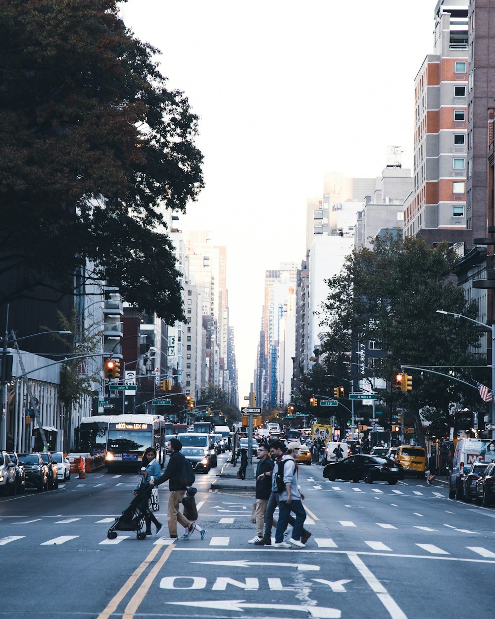 a group of people walking across a street