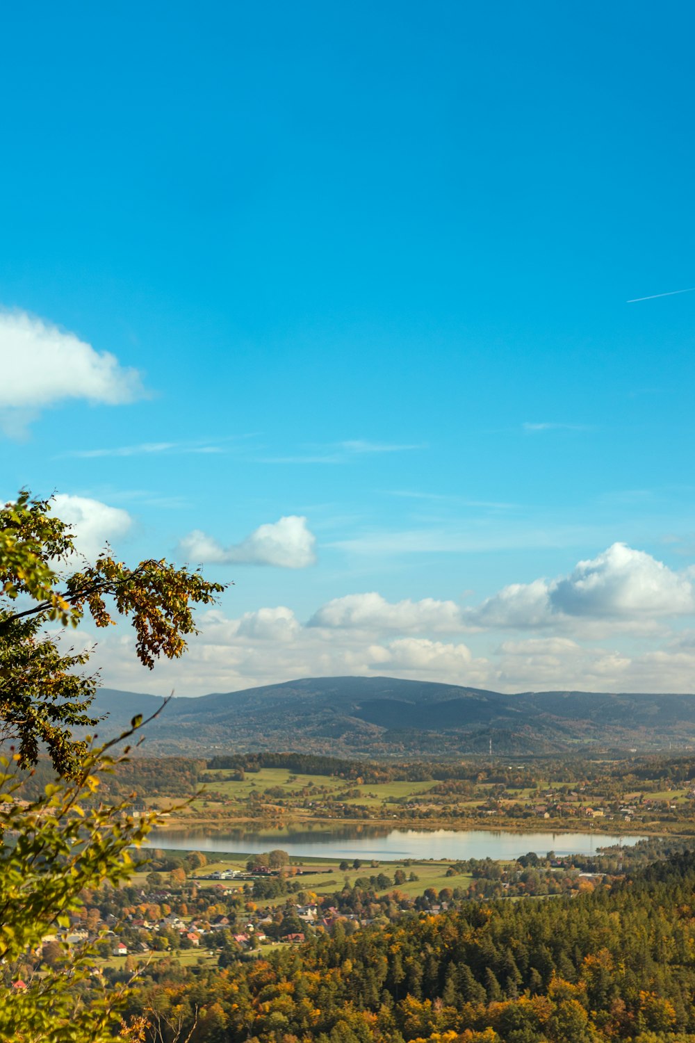 a scenic view of a valley and a lake