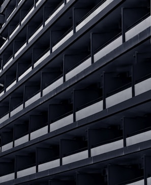 a black and white photo of a building with balconies