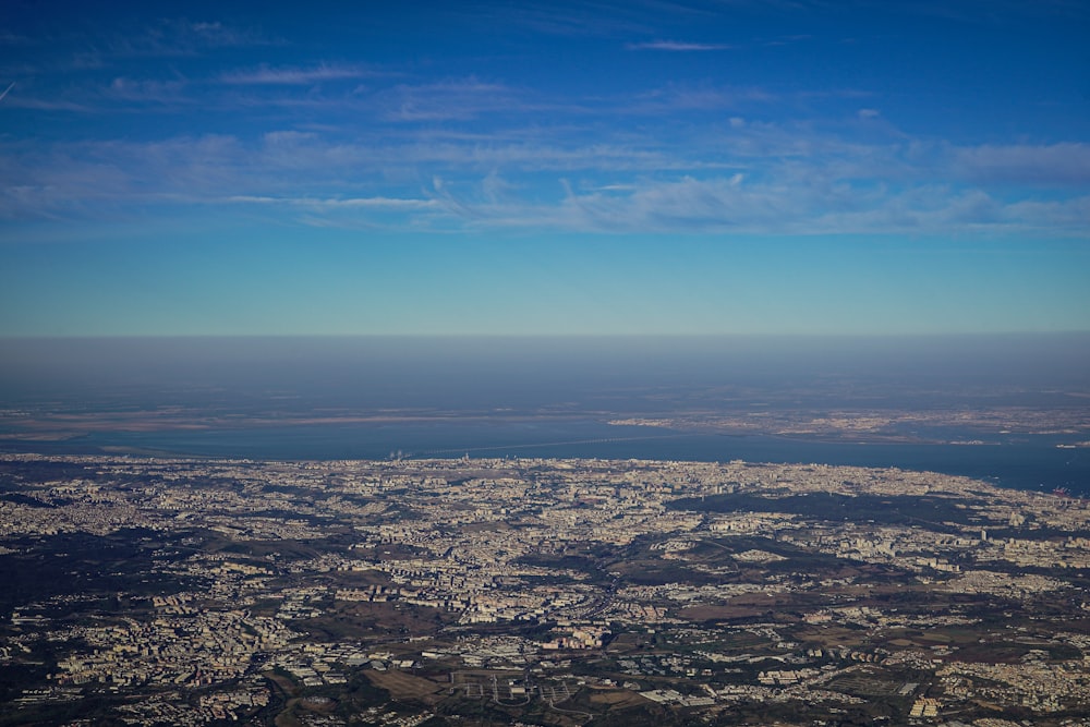 an aerial view of a city and a body of water