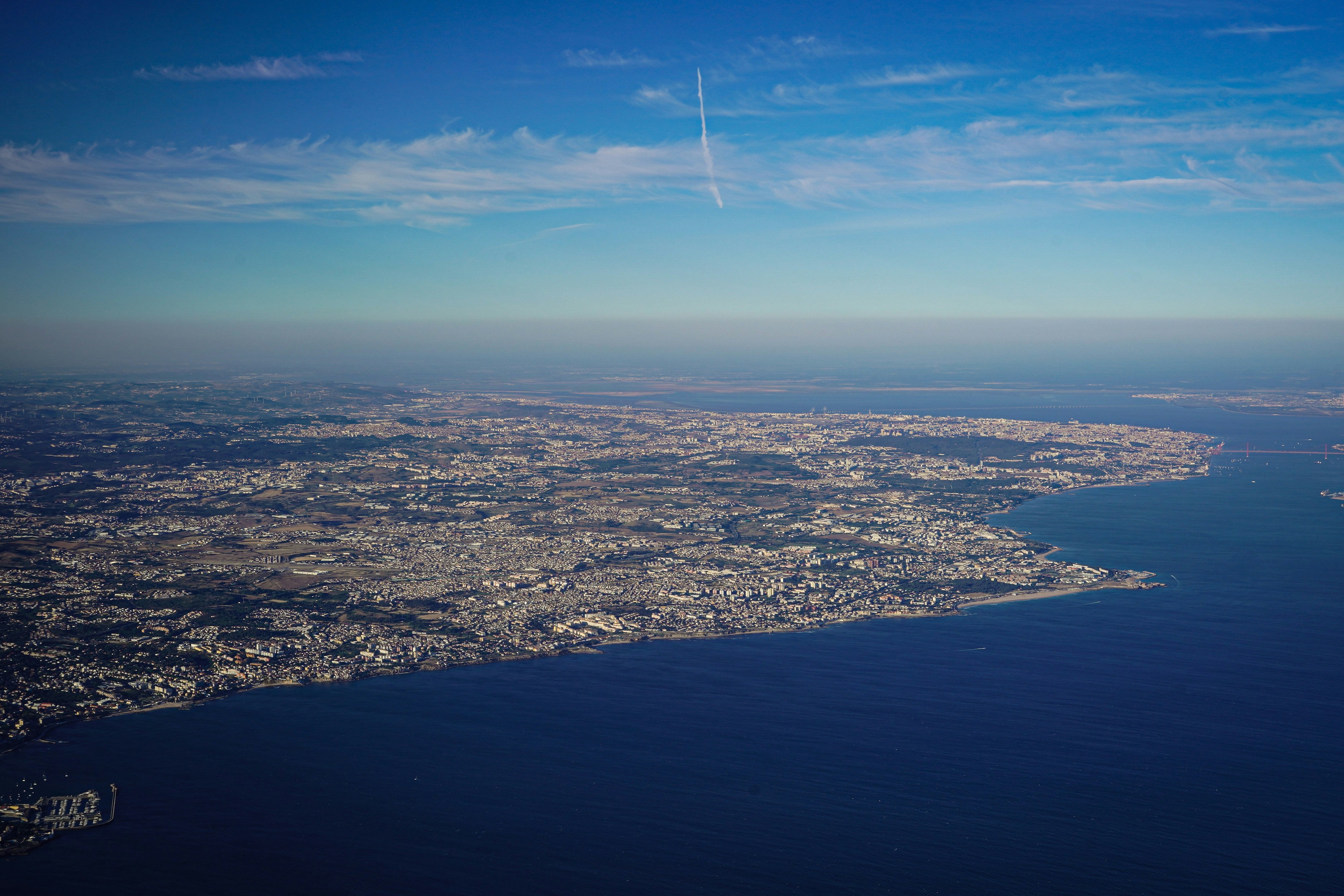 an aerial view of a city and a body of water, Photograph by Mark Stuckey.