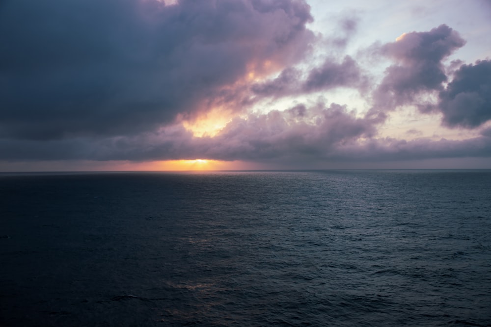 a large body of water under a cloudy sky