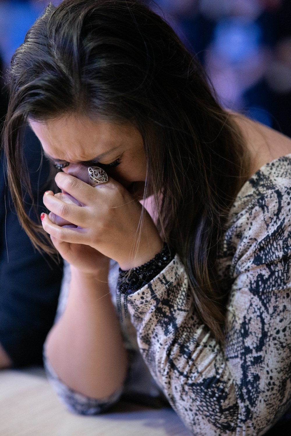 a woman covers her face with her hands