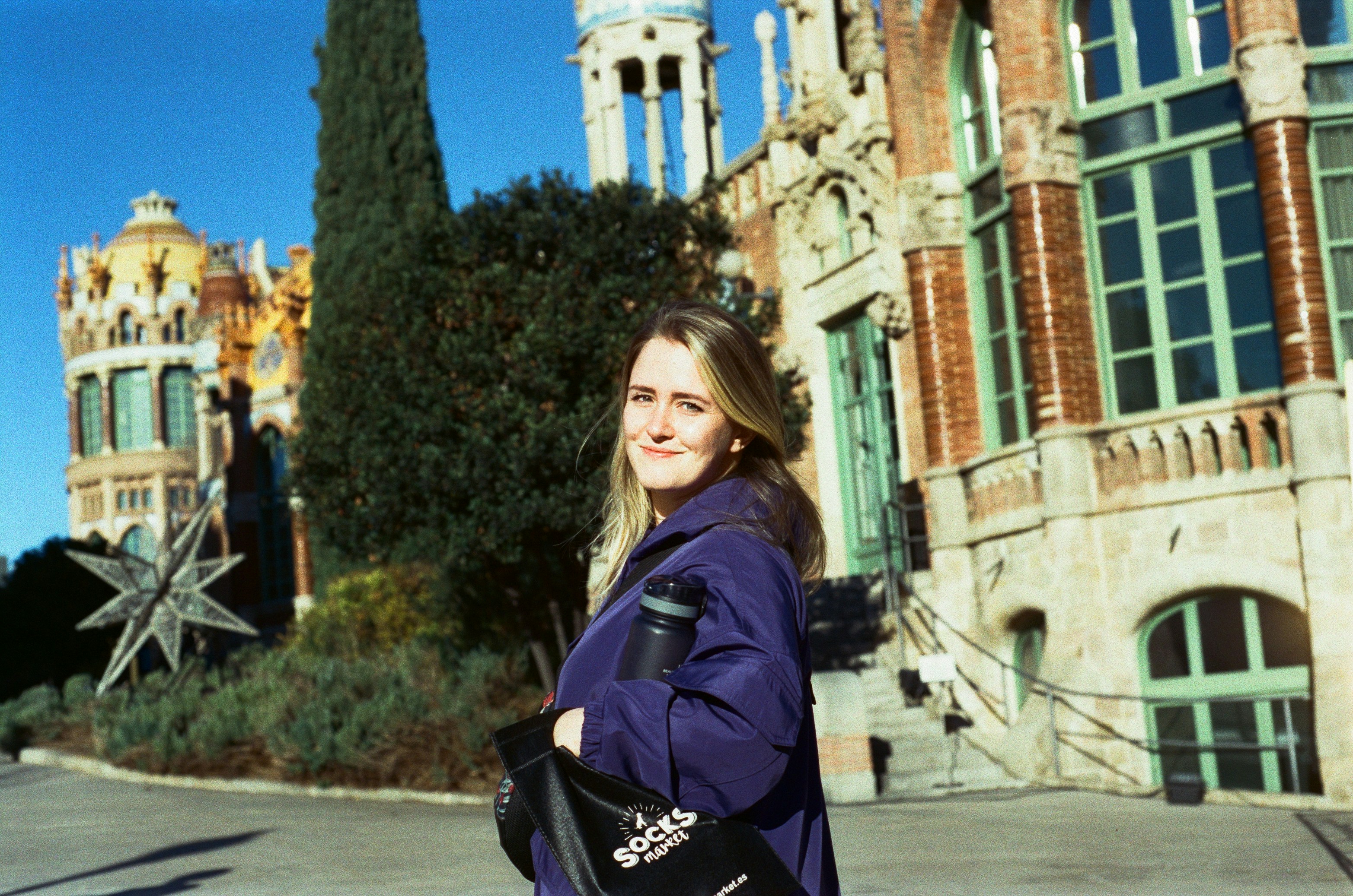a woman is standing in front of a building