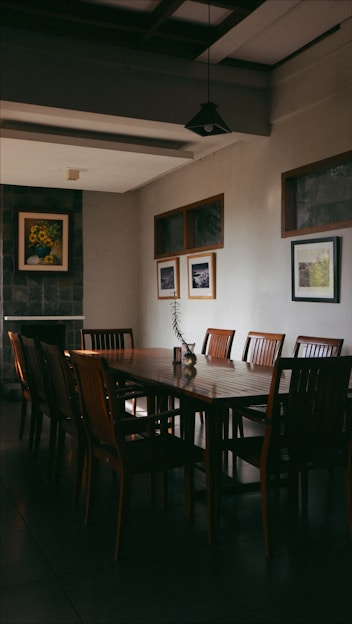 a dining room table with a vase of flowers on it