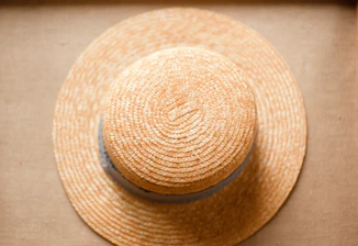 A stylish wide-brimmed hat displayed against a clean, neutral backdrop.
