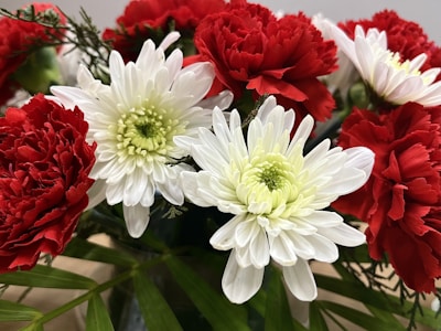 Sympathetic floral arrangement for a casket featuring deep red and cream flowers.
