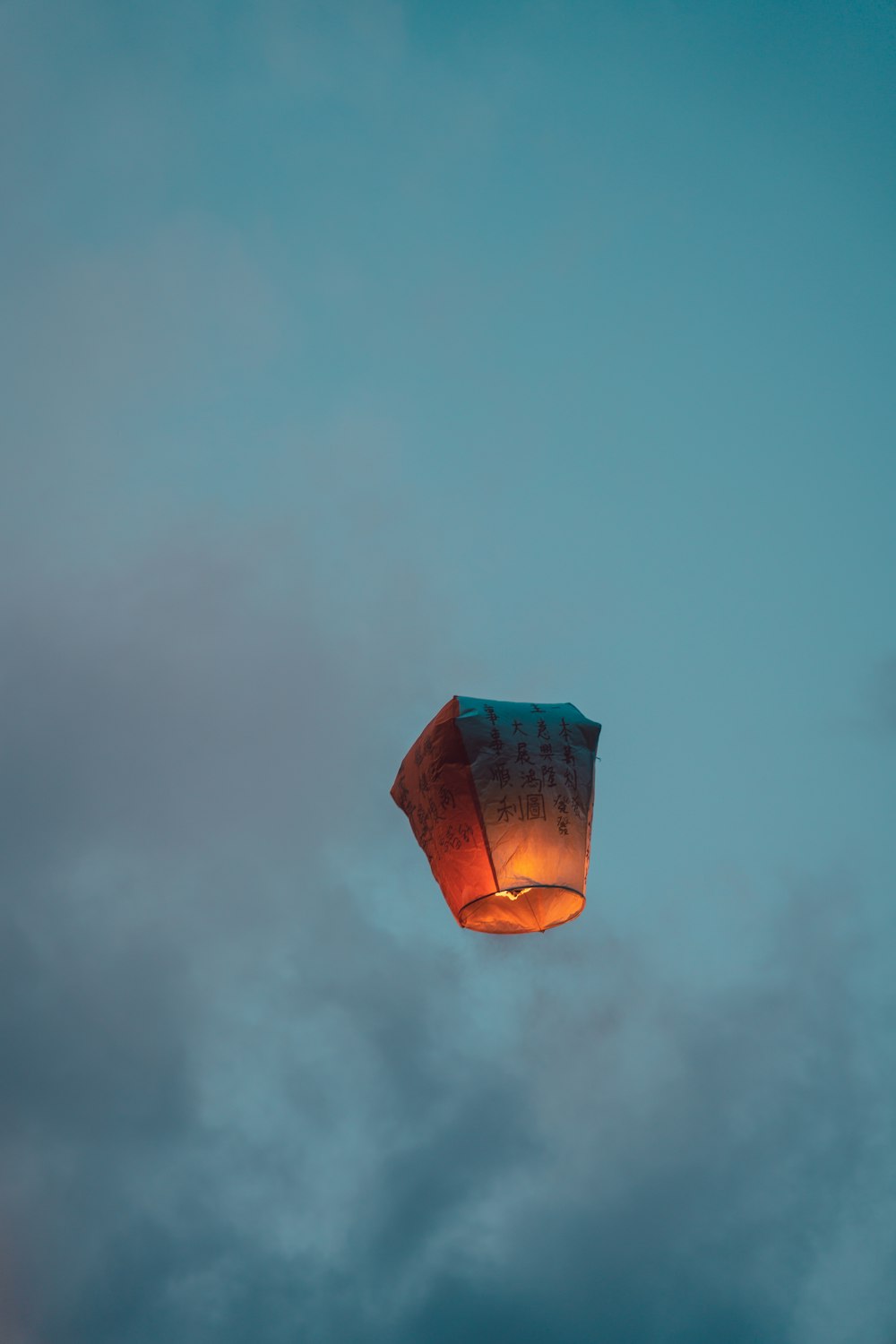 a hot air balloon flying through a cloudy sky