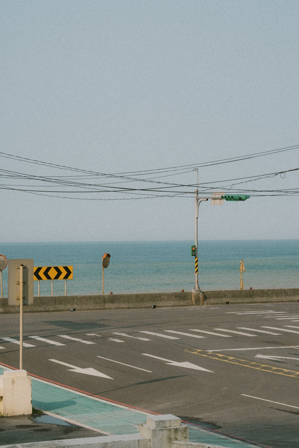 an empty street next to a body of water