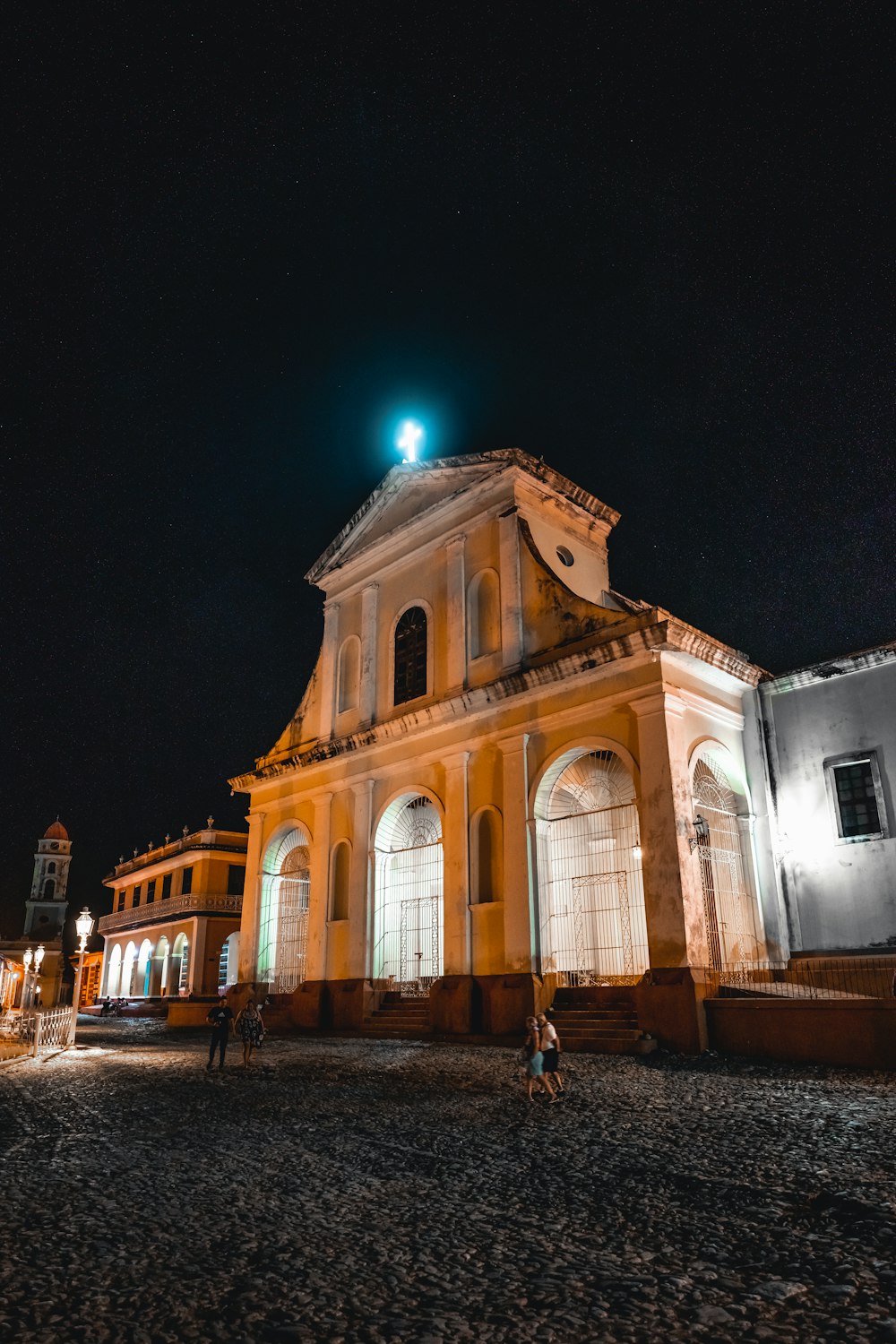 a large building with a clock tower at night