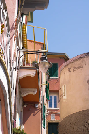 A charming street in Marseille bathed in warm afternoon light, with colorful buildings and a glimpse of the old port.