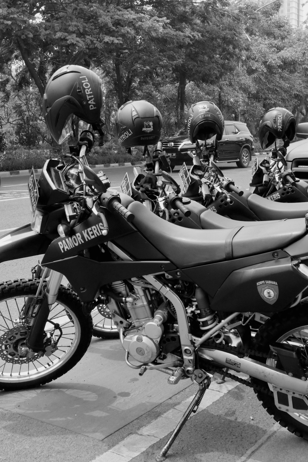 a row of motorcycles parked on the side of the road