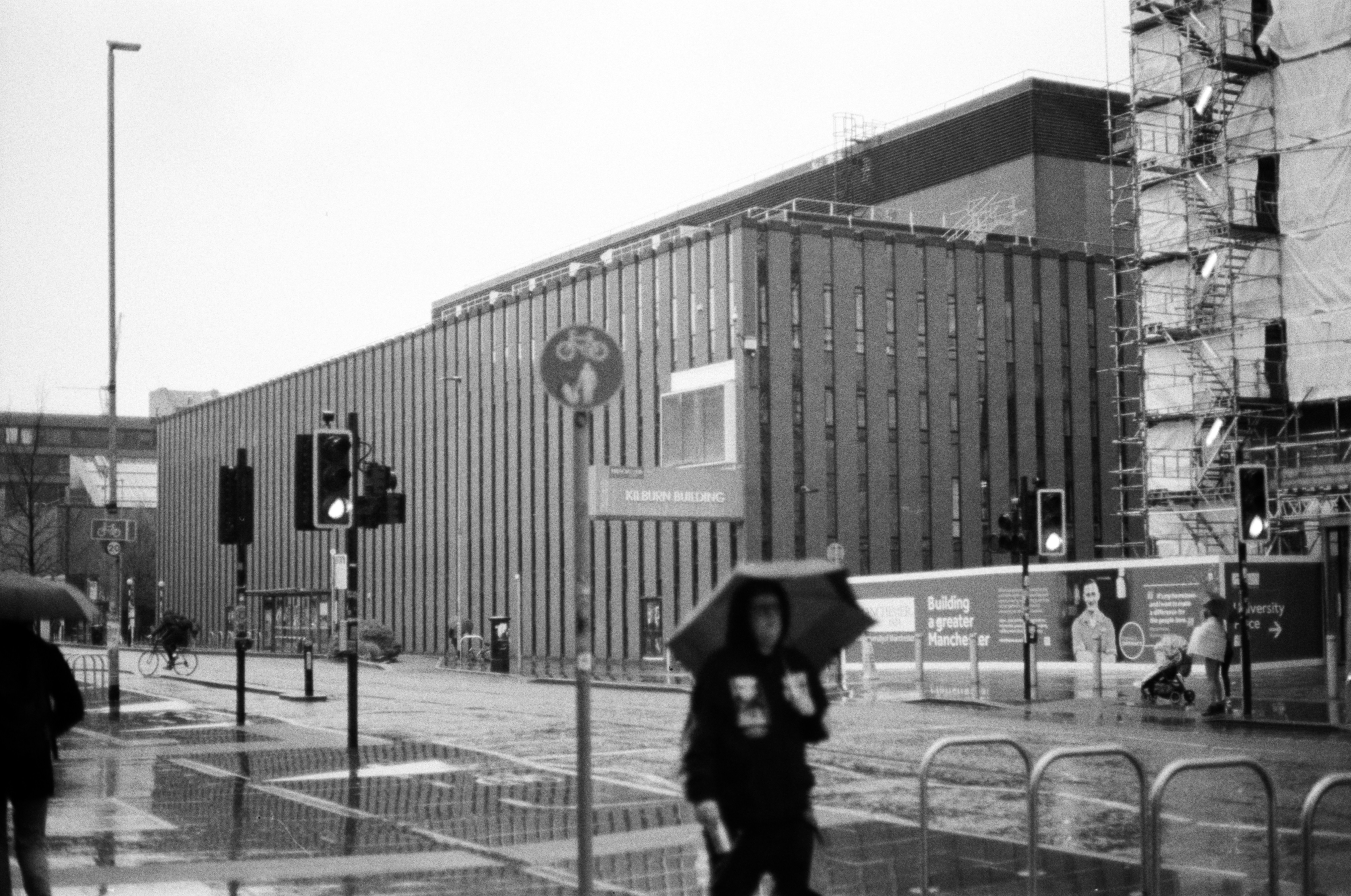 a black and white photo of people with umbrellas