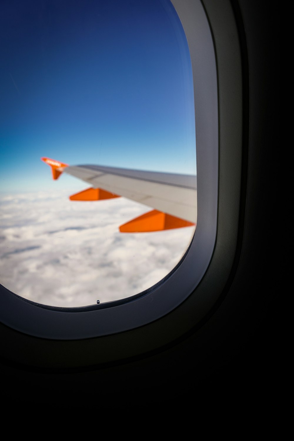 a view of the wing of an airplane in the sky