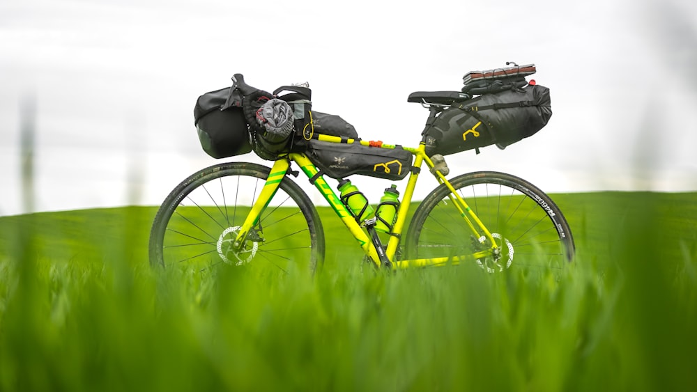 a yellow bike with a bag on the back of it