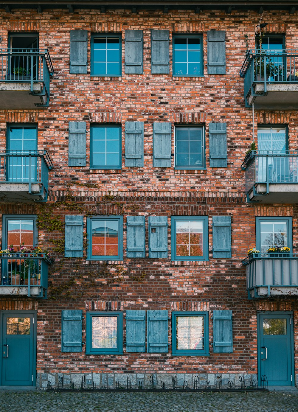 a tall brick building with many windows and balconies