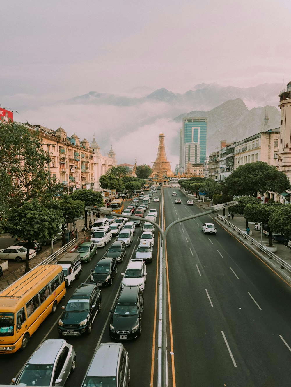 a street filled with lots of traffic next to tall buildings