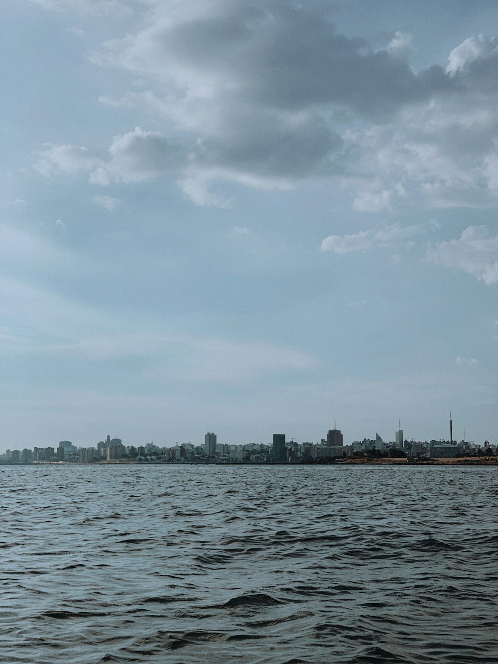 a large body of water with a city in the background