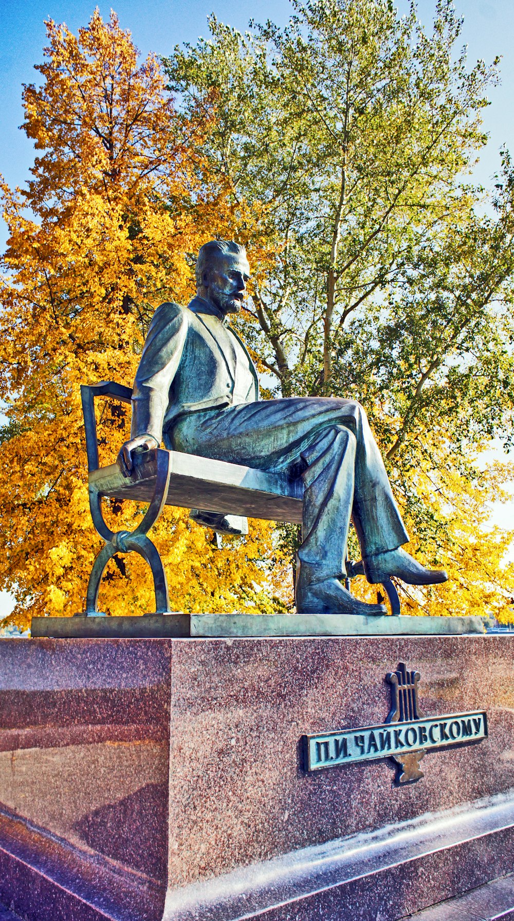 a statue of a man sitting on a bench