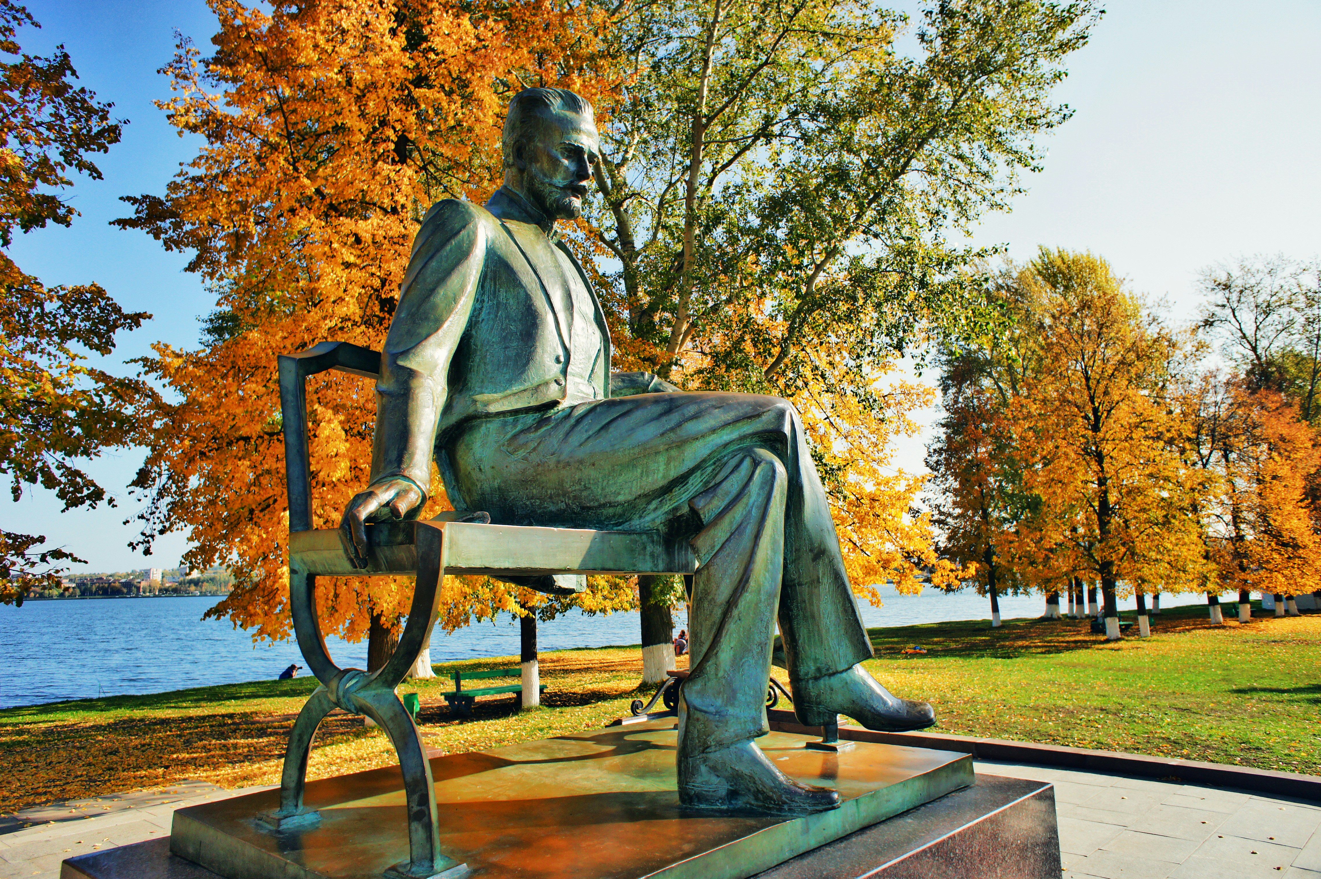 a statue of a man sitting on a bench