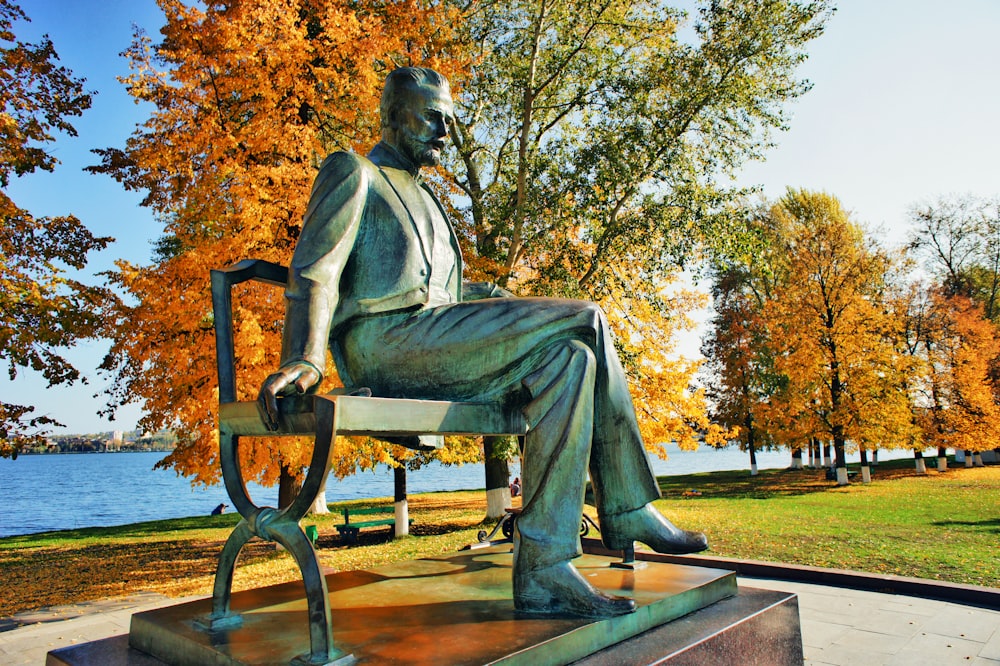 a statue of a man sitting on a bench