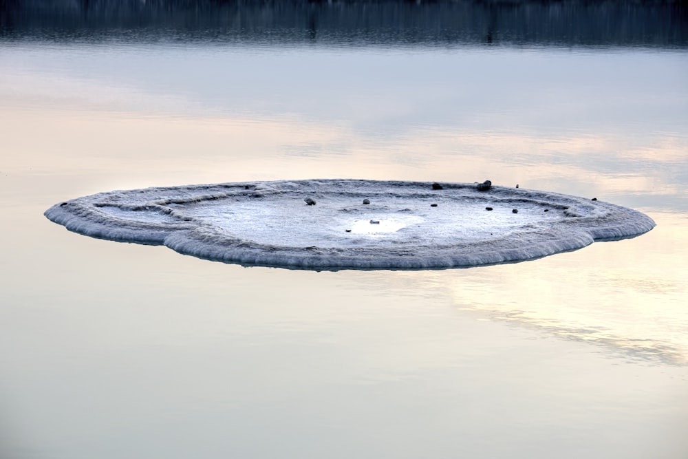 a large piece of ice floating on top of a lake